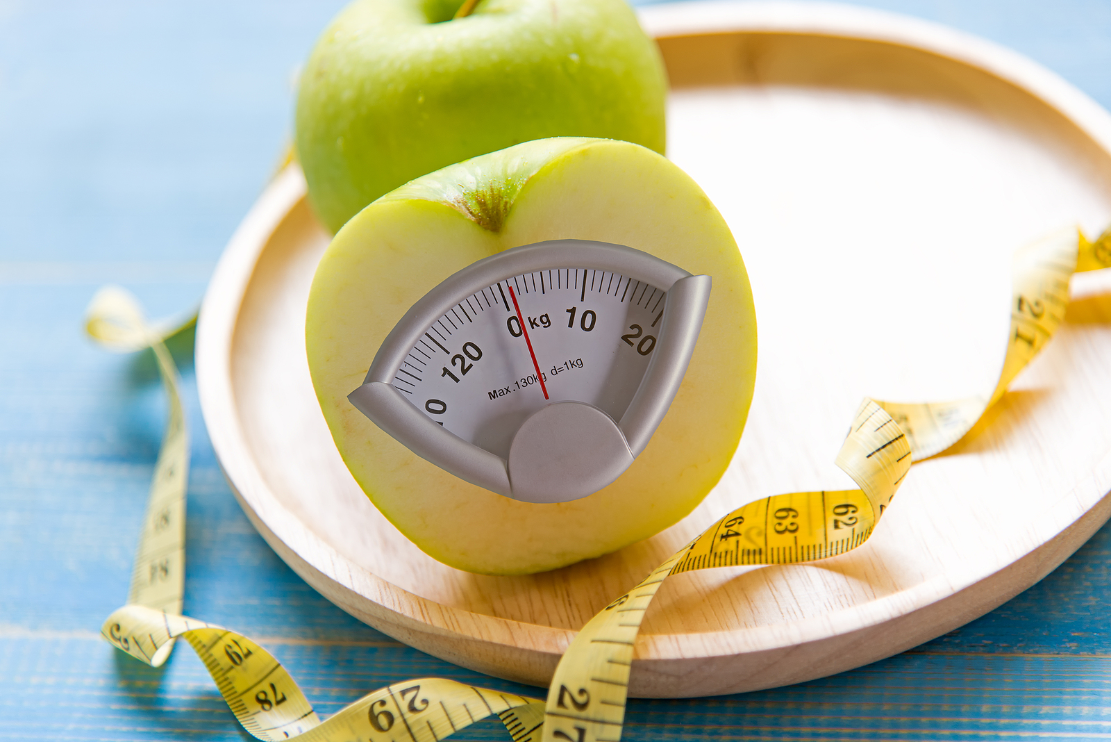 Green apple with weight scale